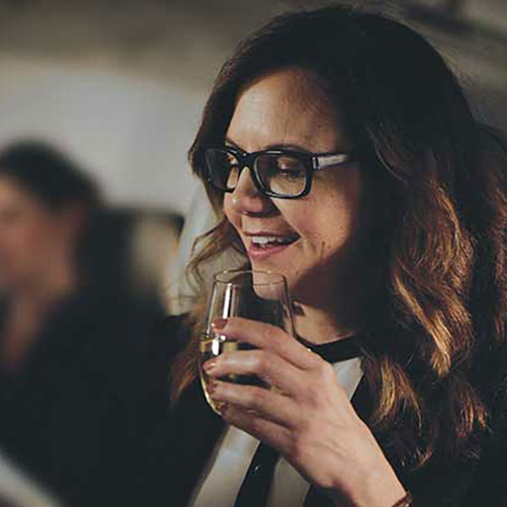 Woman enjoying beverage in the Premium cabin